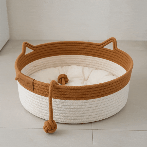 Cat resting in a handwoven rope Territory Nest